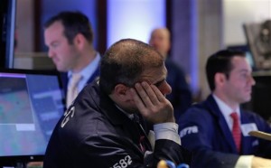 Specialists work on the floor of the New York Stock Exchange Tuesday, Jan. 27, 2015. Wall Street stocks finished sharply lower Tuesday following a disappointing stream of corporate earnings and mixed US economic data.  AP PHOTO/RICHARD DREW