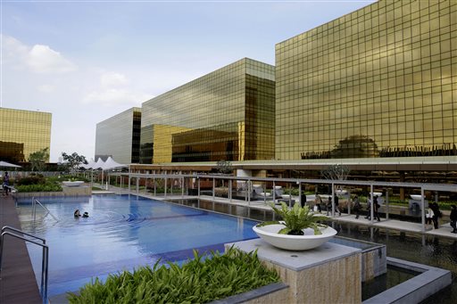 Guests enjoy swimming in a pool at the newly opened City of Dreams Manila casino Monday, Feb. 2, 2015 at the reclaimed prime property in Manila, Philippines.  AP PHOTO/BULLIT MARQUEZ 