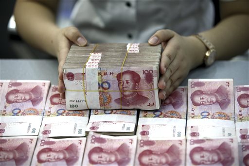 A bank clerk counts renminbi banknotes in a bank branch in Huaibei in central China's Anhui province Wednesday Aug. 26, 2015.   Asian stocks rose Wednesday after a rocky start following Beijing's decision to cut a key interest rate to help stabilize gyrating financial markets and free up more funding to counter short liquidity. AP