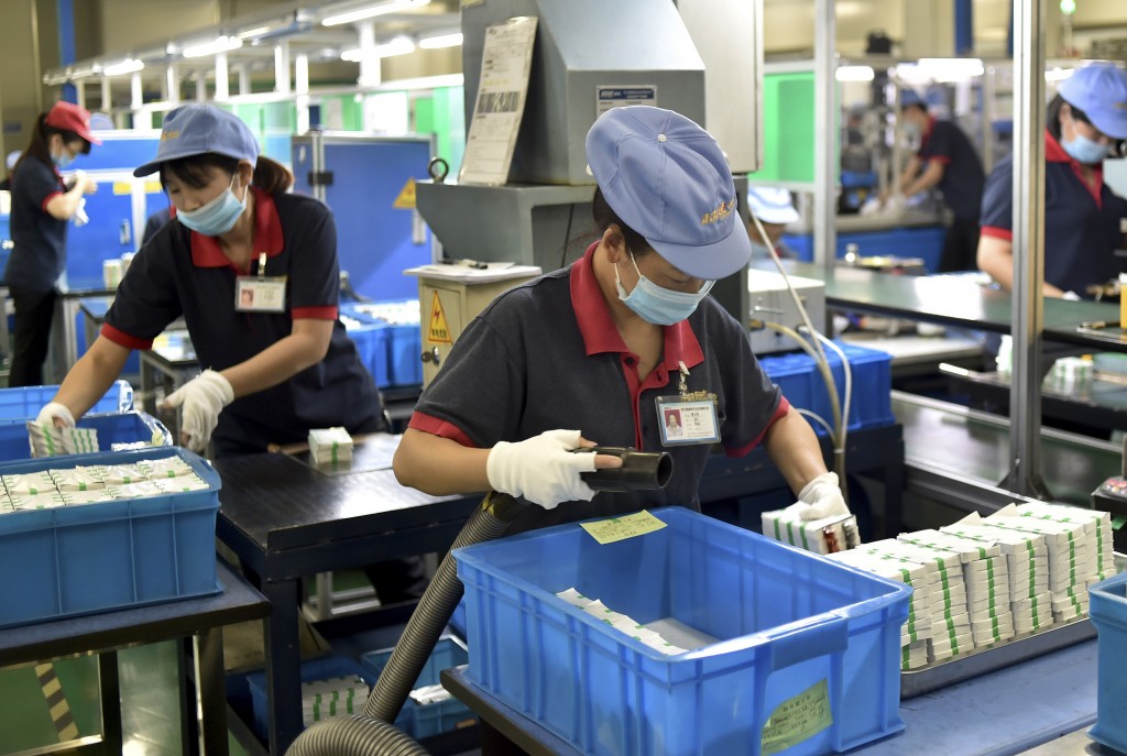 In this Tuesday, Sept. 1, 2015 photo, workers assemble lithium batteries at a factory of Chilwee Group, China's leading battery maker, in Changxing county in east China's Zhejiang province. Chinese Premier Li Keqiang tried Wednesday, Sept. 9 to mollify foreign concerns about its economic slowdown, saying growth is in the "proper range" and Beijing has no plans to allow its currency to decline further. (Chinatopix via AP) 