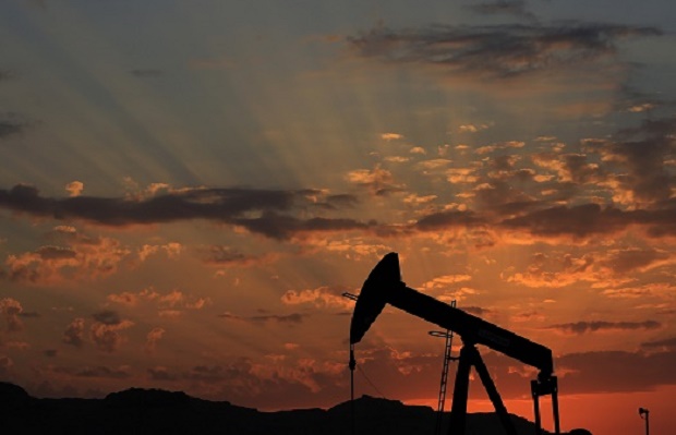 FILE - In this Dec. 13, 2015 file photo the sun sets behind an oil pump in the desert oil fields of Sakhir, Bahrain. Oil futures spiked briefly on Monday, Jan. 4, 2016, after the news that Saudi Arabia would cut diplomatic ties with Iran, a development that could be seen as a threat to oil supplies. Investors quickly discounted those fears, however. (AP Photo/Hasan Jamali, File)