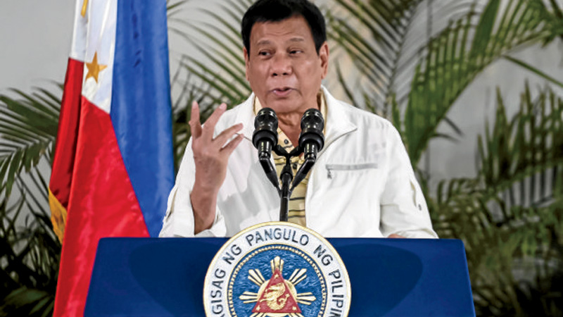 Philippine President Rodrigo Duterte speaks during a press conference at the airport in Davao City, in southern island of Mindanao  prior to his departure for Laos to attend the Asean summit on September 5, 2016.Controversial Philippine President Rodrigo Duterte on September 5 vowed he would not let himself be lectured to on human rights by US President Barack Obama when they meet at a coming summit in Lao / AFP PHOTO / MANMAN DEJETO