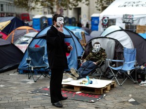 WALL STREET PROTEST. Occupy London protesters wear masks as they continue their demonstration outside St Paul's Cathedral in London, Wednesday, Nov. 16, 2011. Authorities in London said Tuesday they would resume legal action to evict protesters from outside St. Paul's Cathedral after talks with the demonstrators stalled. More than 200 tents have been pitched outside the iconic church for around a month in a protest inspired by New York's Occupy Wall Street. AP