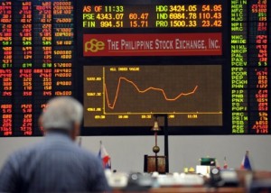A trader looks at the electronic board showing the downward graph of the stocks price index at the Philippine stock exchange. AFP