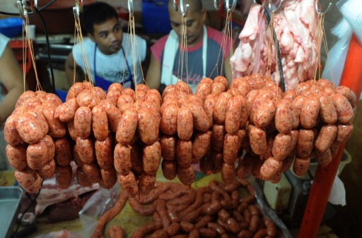 A vendor sells pork sausage in Manila's farmers market on November 4, 2011. Philippine inflation in December settled at 4.2 percent year on year, its lowest level in 11 months as consumer prices dropped by 0.2 percent in December, according to government data released Thursday, Jan. 5, 2012. AFP PHOTO/JAY DIRECTO