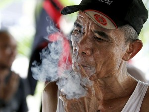An Indonesian man smokes a cigarette in Jakarta, Indonesia, Tuesday, Sept. 11, 2012. Indonesian men rank as the world’s top smokers, with two out of three of them lighting up in a country where cigarettes cost pennies and tobacco advertising is everywhere. AP/Achmad Ibrahim