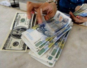The peso is expected to continue depreciating in the near term as the dollar rallies against all currencies due to the recovery in the American economy, posing a threat to the Philippines’ own performance this year.  AFP FILE PHOTO