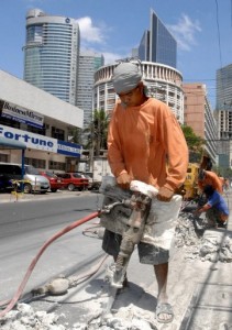 A laborer works on a road project in Makati City in this file photo. The Asian Development Bank has kept its 6.4-percent economic growth forecast for the Philippines this year but has projected a slower 6.3-percent expansion next year. AFP PHOTO/Jay DIRECTO