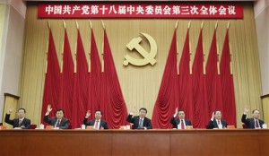 In this photo released by China's Xinhua news agency, Chinese President Xi Jinping, center, and other Communist Party top leaders raise their hands to vote in the third plenary session of the 18th Central Committee of the Communist Party of China, in Beijing Tuesday, Nov. 12, 2013. AP
