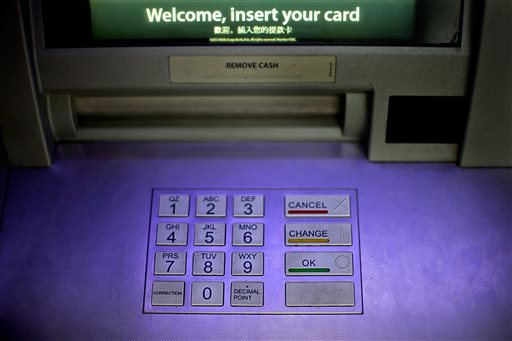 In this Tuesday, July 16, 2013, file photo, an ATM is displayed at a Wells Fargo bank, in Atlanta. Hackers penetrated the computer systems of JPMorgan Chase & Co., the country’s largest bank, stealing names, emails, addresses and phone numbers over the summer of 2014. The theft of personal information from 76 million households naturally raises questions about the safety of money in the digital era. AP