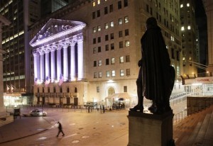 A statue of George Washington stands near The New York Stock Exchange, background on Oct. 8, 2014 in New York. The Dow and S&P 500 Thursday, Nov. 6, closed at new record highs for the second day in a row as investors looked ahead to Friday's jobs report.  AP PHOTO/MARK LENNIHAN