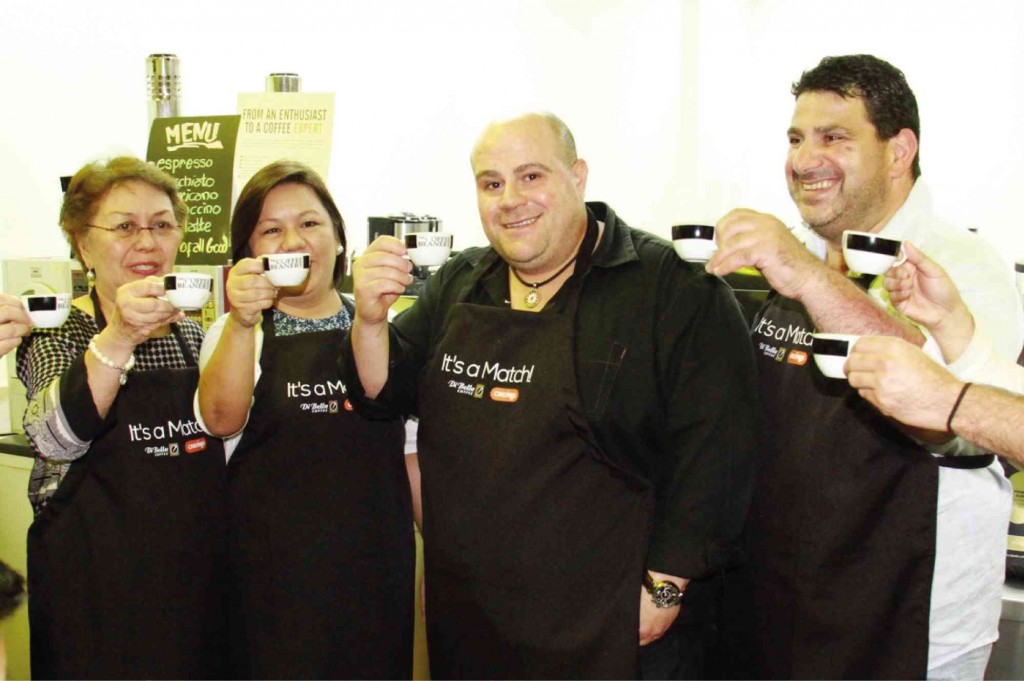 ANNIE P. Guerrero, president of The Cravings Group (TCG); Marinela “Badjie” G. Trinidad, TCG CEO; Phillip Di Bella, founder and managing director of Di Bella Coffee (DBC); and Giuseppe Molinario, DBC business development manager, raise their cups to toast to their partnership at the Coffee Academy. 