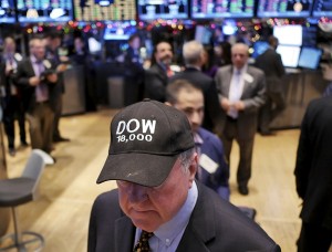 A traders wears a "DOW 18,000" hat on the floor at the New York Stock Exchange in New York, Tuesday, Dec. 23, 2014. The Dow Jones industrial average broke through 18,000 points for the first time Tuesday as the stock market continued a late-year march to record highs. AP