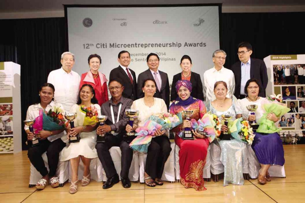 THE WINNERS (seated) of the 12th Citi Microentrepreneurship Awards flash their winning smiles on the day of the awards ceremony. With them are the members of the national selection committee, featuring leaders from business, the public sector, academe and media.