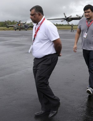 In this Wednesday, Dec. 31, 2014 photo, AirAsia Group CEO Tony Fernandes walks upon his arrival to visit the command center of the search operation for the victims of AirAsia Flight 8501 at the airport in Pangkalan Bun, Indonesia. From the highly visible compassion shown by Fernandes to details such as changing the airline’s bright red logo to a somber gray online, experts say the Malaysia-based budget carrier’s initial response to the tragedy is a textbook example of how to communicate in a crisis.  AP