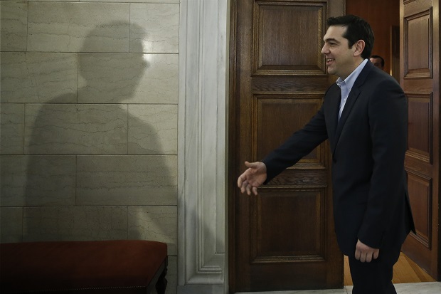 The shadow of Eurogroup chairman Jeroen Dijsselbloem is cast on a wall as Greek Prime Minister Alexis Tsipras waits to greets him during their meeting in Athens, Friday, Jan. 30, 2015. Dijsselbloem is in Athens for talks with Greece’s new left wing government after it promised to renege on key bailout commitments required for repayment of a 240 billion euro ($270 billion) rescue package. (AP Photo/Petros Giannakouris, Pool)
