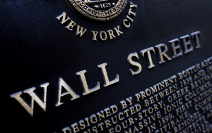 FILE - This Jan. 4, 2010 file photo shows an historic marker on Wall Street in New York. U.S. financial markets eased back from record highs in early trading Wednesday, Feb. 25, 2015.  (AP Photo/Mark Lennihan, File)