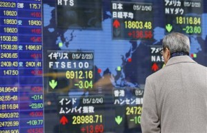 A man watches an electronic stock indicator in Tokyo on Tuesday, Feb. 24, 2015. Asian stocks mostly rose Tuesday as investors awaited details of a Greek reform package crucial to an extension of its bailout, while Fed chair Janet Yellen's upcoming Congressional testimony was also in focus.  AP PHOTO/SHIZUO KAMBAYASHI 