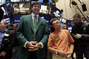 Defending Masters Champion Bubba Watson, left, and 10-Year-Old Drive, Chip & Putt Champion Kelly Xu, of Santa Monica, Calif., visit the trading floor of the New York Stock Exchange on Tuesday, March 24, 2015. Wall Street stocks finished lower Tuesday after positive economic data lifted speculation the US Federal Reserve could move more quickly to raise interest rates.  AP PHOTO/RICHARD DREW