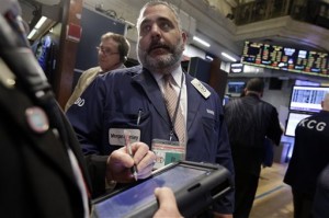 Trader Mario Innella works on the floor of the New York Stock Exchange, Wednesday, March 11, 2015. US stocks finished lower Wednesday in choppy trade as the dollar hit a new 12-year high against the euro.  AP PHOTO/RICHARD DREW
