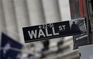 This Oct. 2, 2014, photo shows a Wall Street sign adjacent to the New York Stock Exchange, in New York. US stocks mostly fell Tuesday, April 21, but the Nasdaq stayed in positive territory as Israel's Teva announced a $40.1 billion cash-and-stock bid for generic drug maker Mylan.  AP PHOTO/RICHARD DREW 