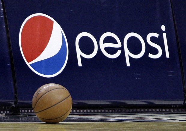 FILE - In this Oct. 7, 2009 file photo, a court side ad displays the Pepsi logo during a time out in an NBA preseason basketball game between the Orlando Magic and the Miami Heat in Orlando, Fla. The NBA on Monday, April 13, 2015 said that it's struck a new marketing partnership with Pepsico, ending a 28-year partnership with Coca-Cola. (AP Photo/John Raoux, File)