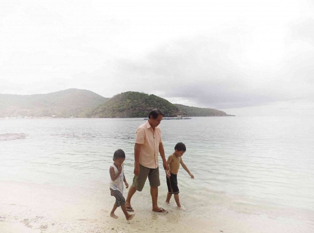 MAYOR Cipriano shows off  Sibale Beach to a visitor from Manila, Rainier Soledad, 7, and a local boy.