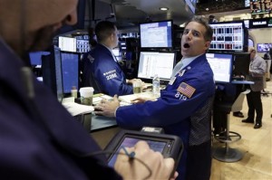 Specialist Anthony Rinaldi, right, works at his post on the floor of the New York Stock Exchange on Tuesday, May 19, 2015. Wall Street stocks finished mixed Tuesday in a choppy session following disappointing Walmart earnings and a pullback in many petroleum stocks.  AP PHOTO/RICHARD DREW 