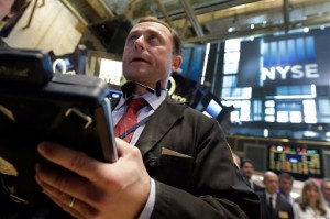 Trader George Baskinger works on the floor of the New York Stock Exchange on Tuesday, May 26, 2015. Wall Street stocks fell sharply Tuesday on a strengthening US dollar despite news of Charter Communication's $78.7 billion deal to buy Time Warner Cable.  AP PHOTO/RICHARD DREW  