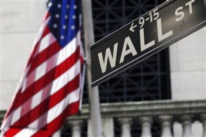 This July 15, 2013, file photo shows the American flag and Wall Street street sign outside the New York Stock Exchange in New York. Wall Street stocks dipped Thursday, May 28, 2015, following leading eurozone equity markets lower on worries about a potential Greek exit from the currency bloc.  AP PHOTO/MARK LENNIHAN 