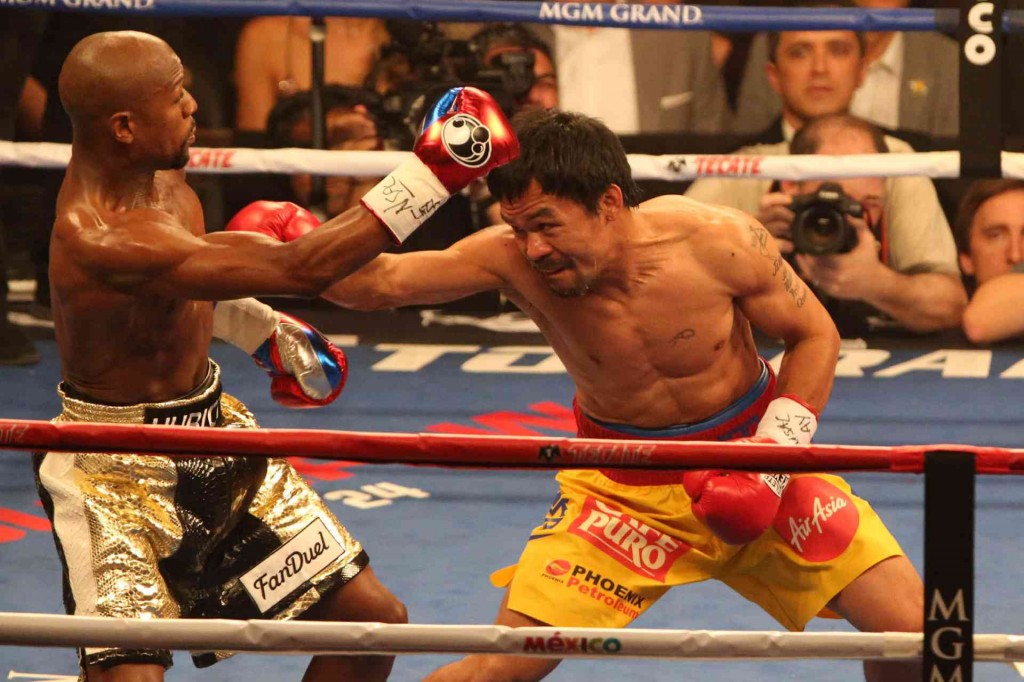 MANNY Pacquiao (right) and Floyd Mayweather slug it out during the much-awaited event. From the match comes lessons businessmen may live by.  Rem Zamora