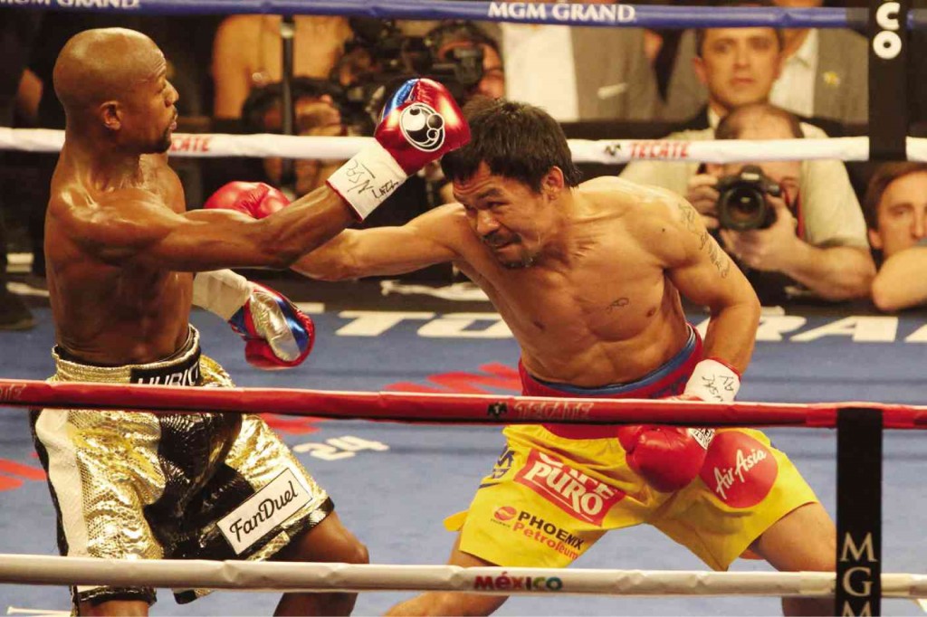 DODGING THE “LUCKY PUNCH”Manny Pacquiao and Floyd Mayweather Jr. mix it up.  REM ZAMORA 
