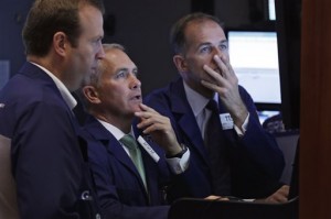 Timothy Nick, center, works with fellow traders in his booth on the floor of the New York Stock Exchange on Tuesday, June 2, 2015. US stocks finished lower Tuesday in choppy trade, following European equities downward after a senior EU official complained of slow progress in talks to avoid Greek debt default.  AP PHOTO/RICHARD DREW  