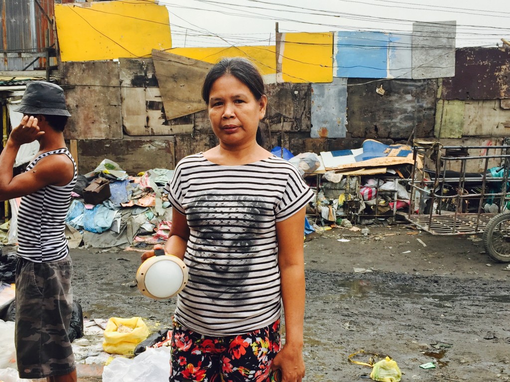 A mother rents a solar-powered lamp in Tondo, Manila. YUJI GONZALES 