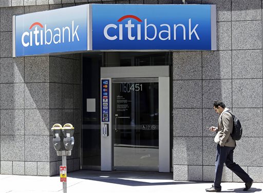 In this photo taken, Wednesday, July 9, 2014, a man walks past a branch of Citibank in the Financial District in San Francisco. Citigroup reports second-quarter results on Thursday, July 16, 2015. AP