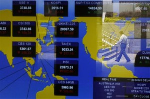 A man is reflected in a screen showing stock indexes of Asian markets at Hong Kong Exchanges in Hong Kong on Wednesday, July 8, 2015. Asian equities tumbled Wednesday as a collapse in Chinese shares began to contaminate other markets, and after European leaders slapped Greece with a deadline to submit fresh bailout reform proposals.  AP PHOTO/KIN CHEUNG