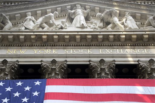 FILE - In this July 6, 2015 file photo, an American flag is draped on the exterior of the New York Stock Exchange. Global stock markets mostly rose on Wednesday, July 15, 2015, after China posted better-than-expected economic growth in the second quarter. Investors are awaiting the Greek parliamentary vote on a bailout deal and the Fed chair's speech on the U.S. economic outlook. (AP Photo/Mark Lennihan, File)