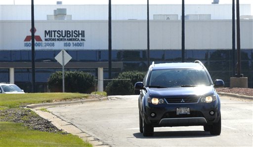 An employee leaves the Mitsubishi Motors North America plant Friday, July 24, 2015, in Normal, Ill., driving the plant's sole product, an Outlander. The company's North American spokesman Dan Irvin said Friday that the Japanese automaker has completed a review of its global supply chain and been informed it is "necessary" to end production and find a buyer for the plant. (David Proeber/The Pantagraph via AP)