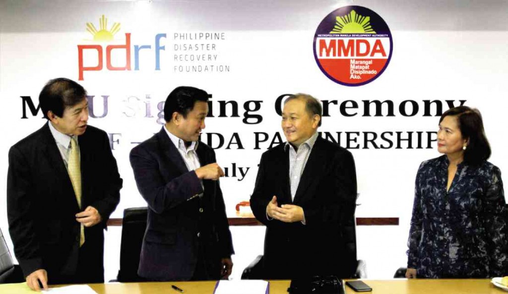 (from left) Philippine Disaster Recovery Foundation (PDRF) president Rene Meily, MMDA chair Francis Tolentino, PDRF co-chair and head of PLDT Smart and Metro Pacific Group Manuel V. Pangilinan and MMDA Undersecretary Corazon Jimenez during the signing of the agreement to work together on disaster preparedness. RICHARD A. REYES