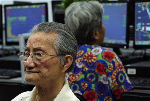 Chinese stock investors monitor stock prices at a brokerage house in Jiujiang in central China's Jiangxi province Tuesday, Aug. 25, 2015.  AP