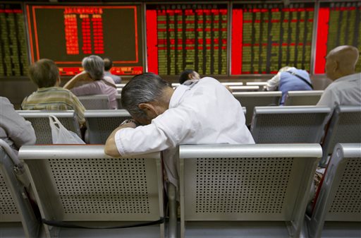 Chinese investors monitor stock prices at a brokerage house in Beijing, Tuesday, Aug. 25, 2015.  AP