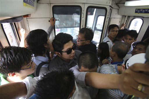 In this Tuesday, Aug. 11, 2015 photo, Filipino passengers ride a crowded train of the Manila Metro Rail Transit System during rush hour in the financial district of Makati, south of Manila, Philippines. AP