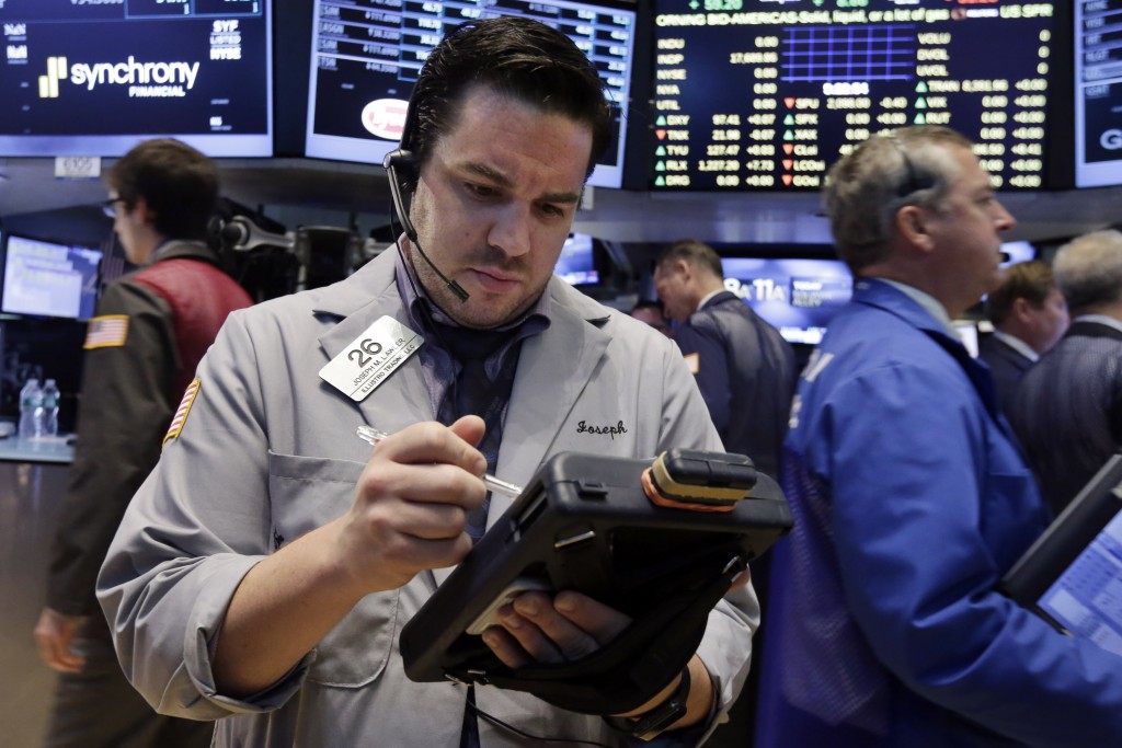 TTrader Joseph Lawler works on the floor of the New York Stock Exchange on Monday, Aug. 3, 2015. US stocks fell Monday with petroleum-linked equities retreating on a big drop in oil prices as Wall Street girds for a busy week of economic reports.  AP PHOTO/RICHARD DREW