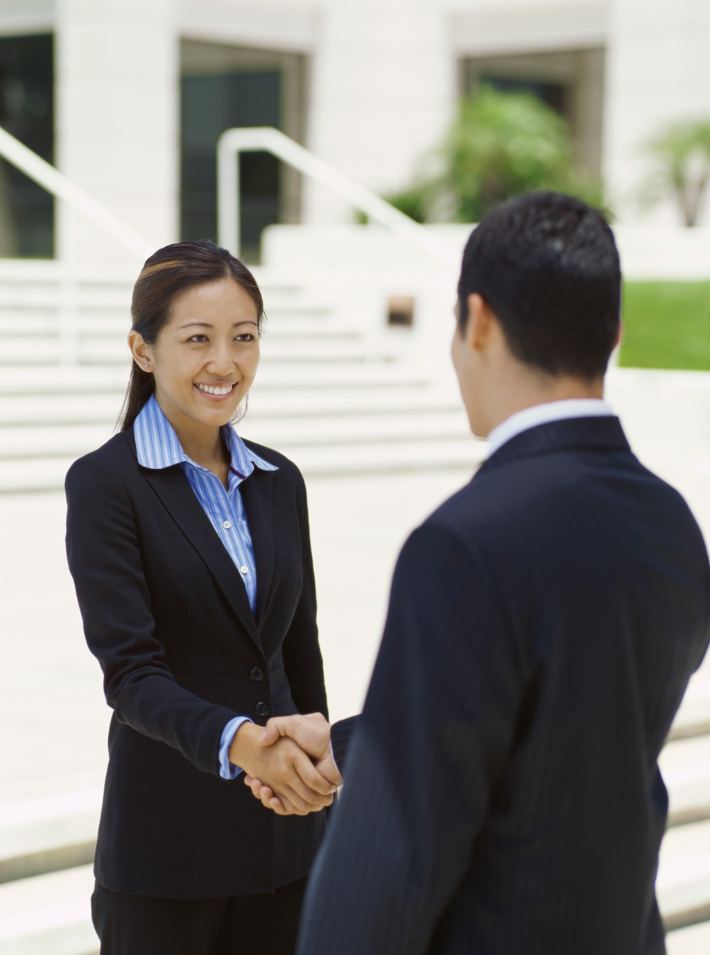 businessman and a businesswoman shaking hands