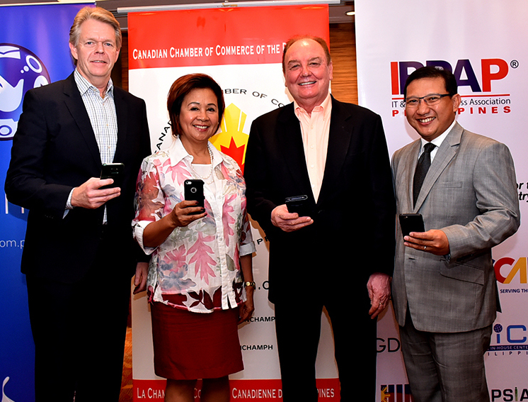 (L-R) Globe Senior Advisor for Enterprise and IT-Enabled Services Group Mike Frausing, CanCham Executive Director Cora de la Cruz, CanCham President Julian Payne, and IBPAP Chairman of the Board of Trustees Danilo Reyes hold up their mobile phones to recognize how Globe Telecom provides connectivity to the event. 