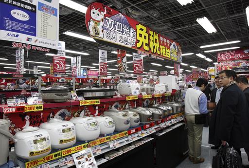 In this March 25, 2010, file photo, Chinese customers look at rice cookers displayed under a banner written in Chinese and Korean: "Welcome, Duty Free counter" at Yodobashi Camera in Tokyo's Akihabara electronics district. The Chinese government's latest plan to transform itself into a consumer driven economy encourages the production of better consumer appliances, reducing reliance on foreign made goods. (AP Photo/Koji Sasahara, File)