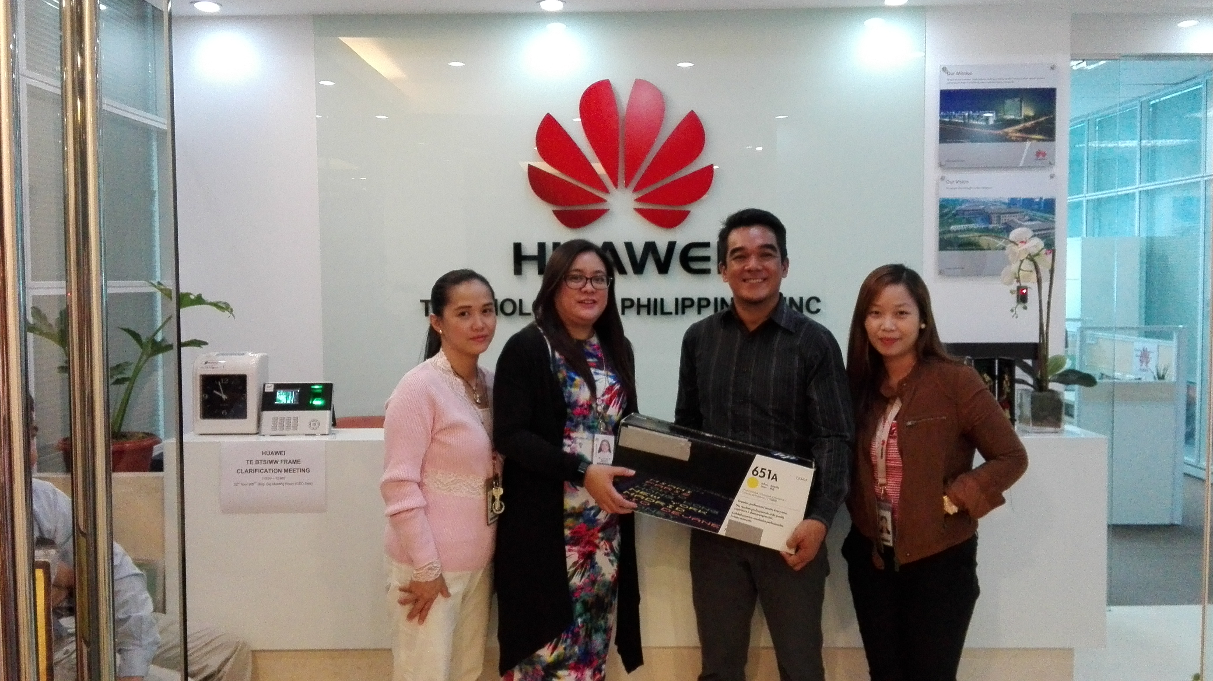 Huawei Technologies Philippines shows support for environmental sustainability through participation in Globe Telecom’s Project 1 Phone. (L-R) Huawei Fixed Assets Manager Angel Fabelico, Huawei PR Manager  Karenina Buenafe and Huawei Procurement Specialist Jocelyn Tesnado turns over a used toner cartridge to Patrick Erestain, Globe Corporate Social Responsibility Manager.