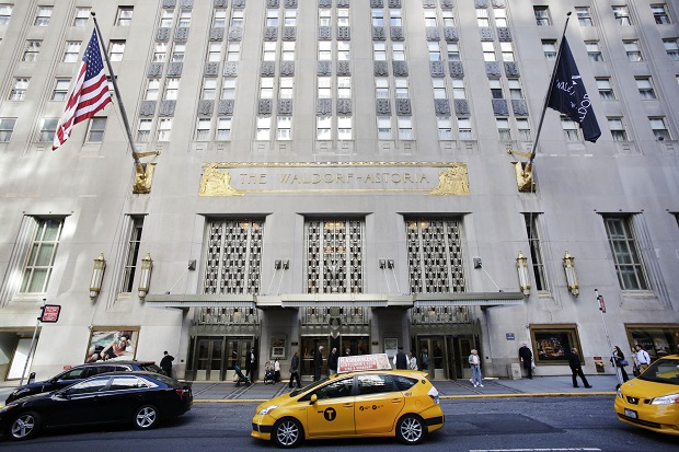 FILE - In this Oct. 6, 2014 file photo, a taxi passes in front of the fabled Waldorf Astoria hotel in New York. A police source said a wedding guests gun went off accidentally at New Yorks Waldorf Astoria Hotel, Saturday, June 13, 2015, and a few people suffered minor injuries from debris. (AP Photo/Mark Lennihan, File)
