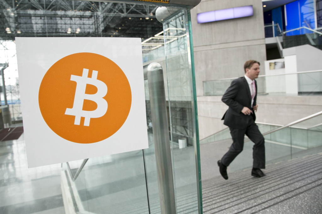 FILE - In this April 7, 2014 file photo, a man arrives for the Inside Bitcoins conference and trade show in New York. An Australian man long thought to be associated with the digital currency Bitcoin has publicly identified himself as its creator. BBC News said Monday, May 2, 2016  that Craig Wright told the media outlet he is the man previously known by the pseudonym Satoshi Nakamoto. The computer scientist, inventor and academic says he launched the currency in 2009 with the help of others. (AP Photo/Mark Lennihan, File)