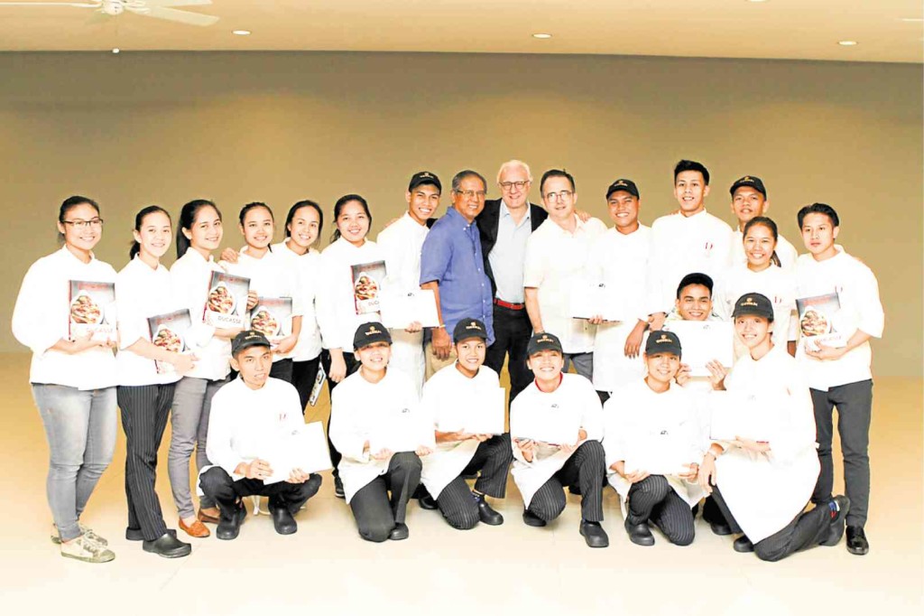 CHEF Alain Ducasse with Youth With A Future scholars and graduates, Father Rocky of Tuloy Foundation and Chef Marc Chalopin, executive chef of Alain Ducasse Institute Philippines       PAUL DALMACIO